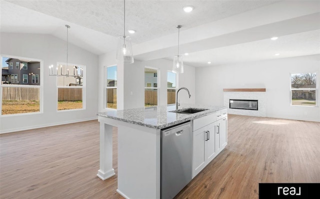5508 Brook St, Papillion, NE 68133 - kitchen featuring dishwasher, a sink, open floor plan, light wood-style flooring, and a glass covered fireplace