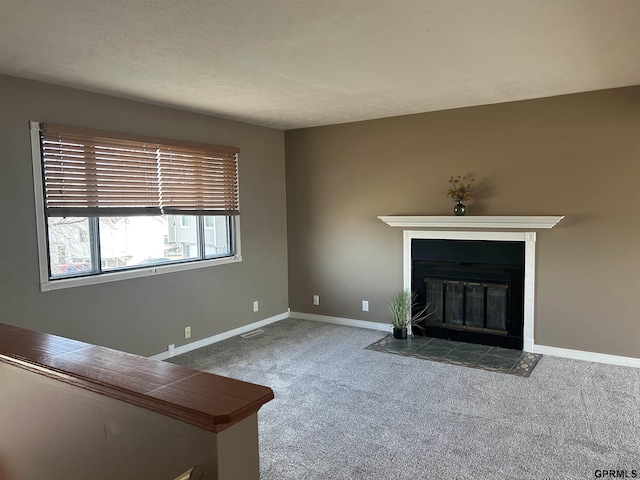 unfurnished living room with a fireplace and carpet flooring