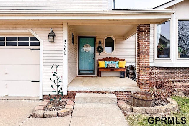 property entrance with a porch and a garage