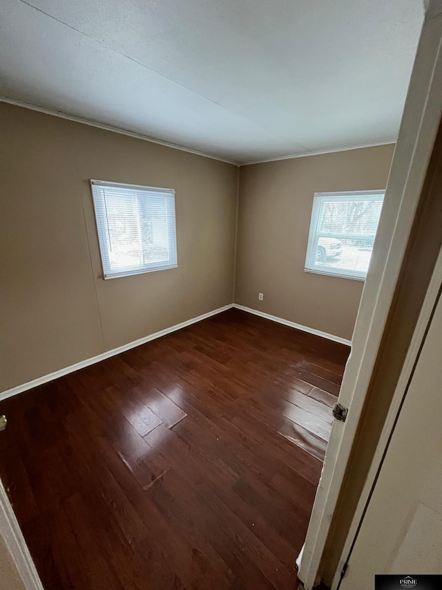 spare room featuring dark hardwood / wood-style floors