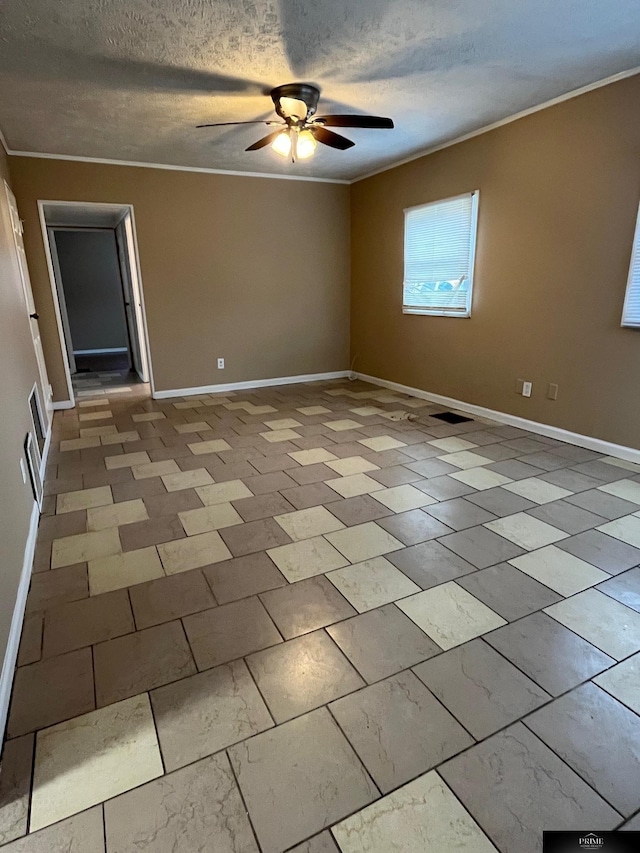 spare room featuring a textured ceiling, ceiling fan, and ornamental molding