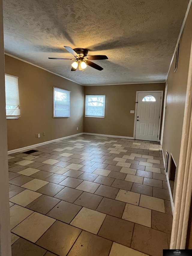 tiled entrance foyer with ceiling fan and a textured ceiling