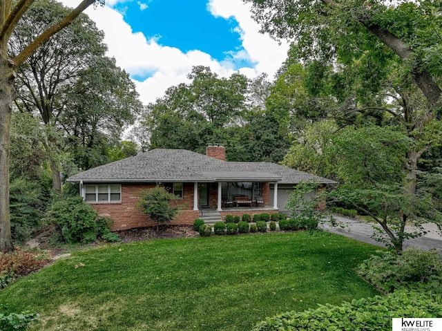 single story home featuring a front yard and a garage