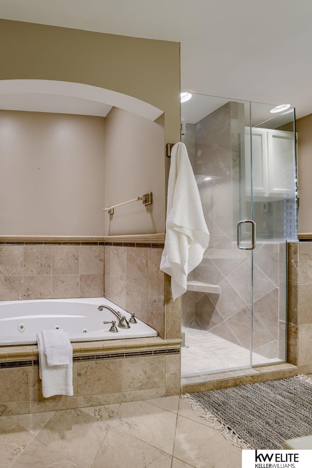 bathroom with tile patterned flooring and independent shower and bath