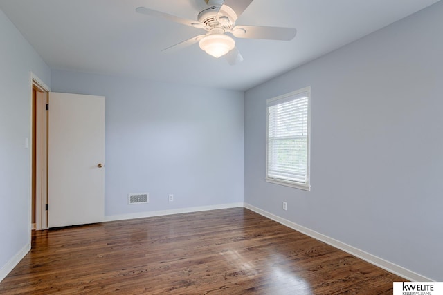 spare room with dark hardwood / wood-style floors and ceiling fan