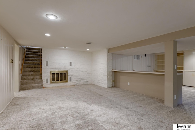 unfurnished living room featuring light colored carpet and a fireplace