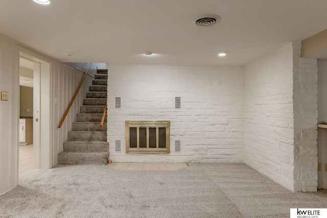 unfurnished living room featuring light colored carpet and a fireplace