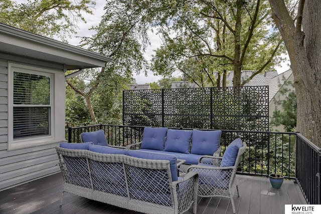 wooden terrace with an outdoor hangout area