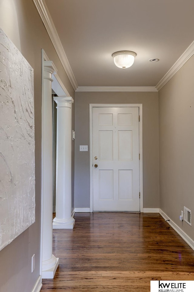 interior space with dark hardwood / wood-style flooring, ornate columns, and crown molding