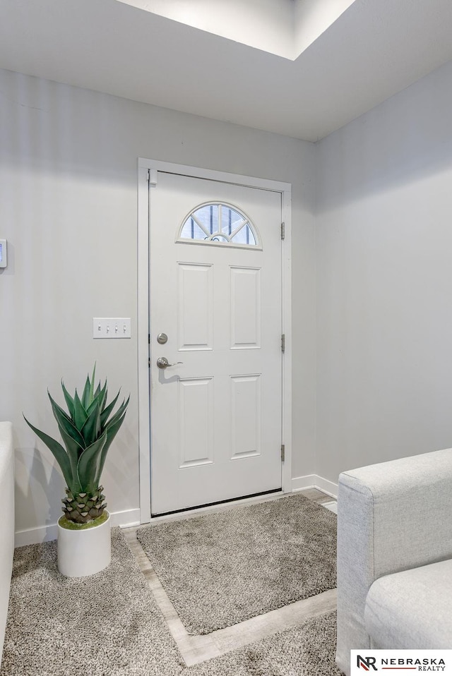 view of carpeted foyer