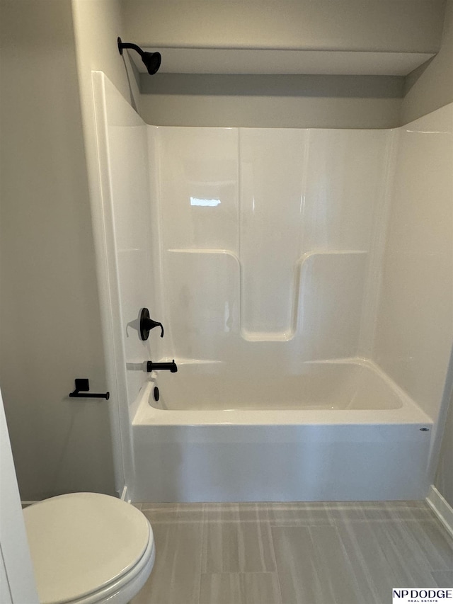 bathroom featuring toilet and shower / washtub combination