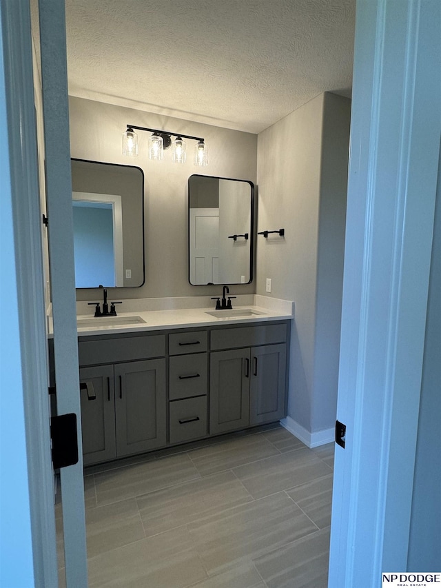 bathroom with vanity and a textured ceiling