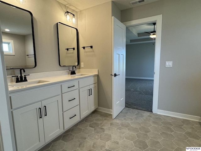 bathroom featuring tile patterned flooring, vanity, and ceiling fan