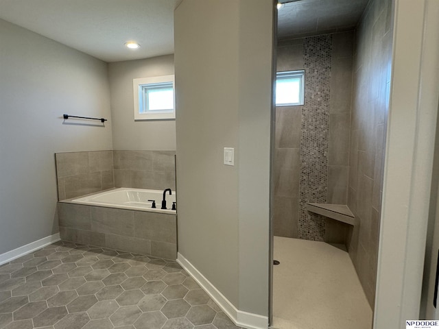 bathroom featuring tile patterned flooring and independent shower and bath