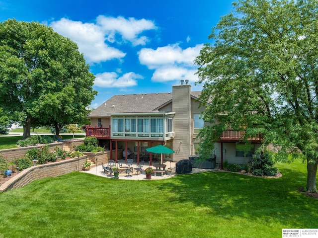 back of house featuring a patio area, a yard, and a wooden deck