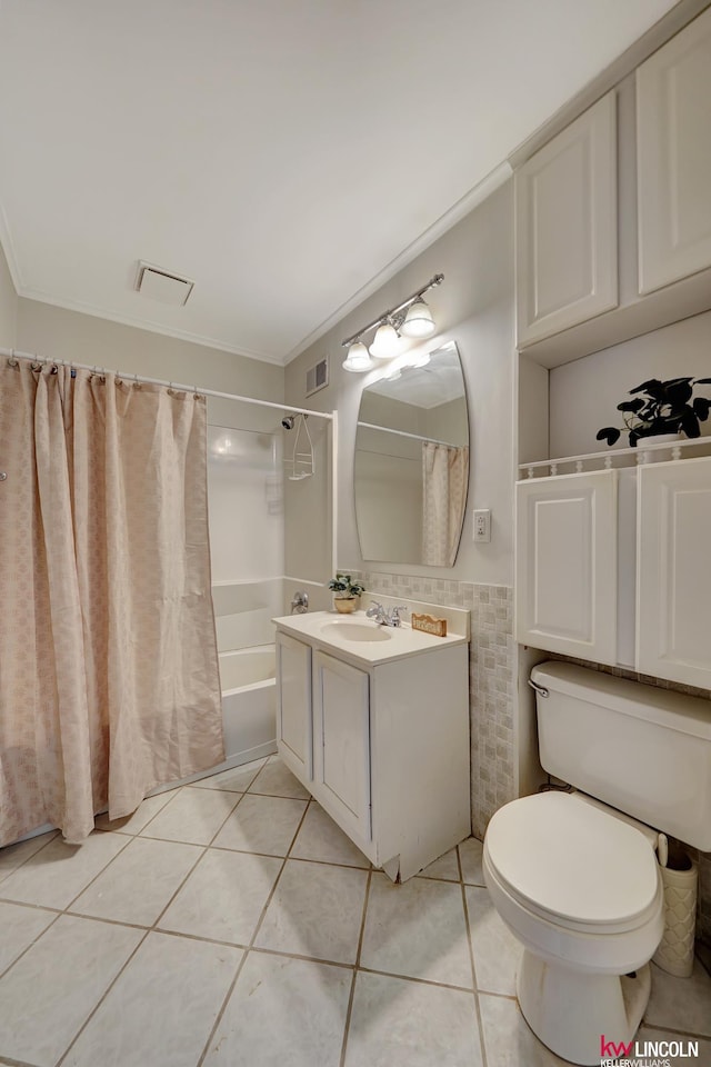 full bathroom featuring tile patterned flooring, toilet, and crown molding