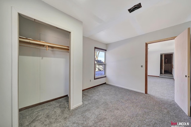 unfurnished bedroom with light carpet and a closet