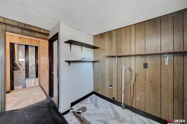 details featuring a textured ceiling and wooden walls