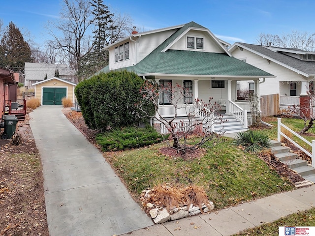 bungalow with an outbuilding, a porch, and a garage