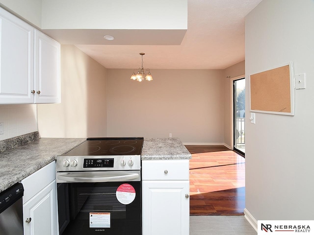 kitchen featuring a chandelier, white cabinetry, hanging light fixtures, and stainless steel appliances