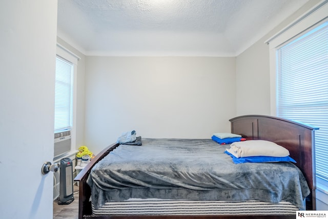 bedroom with hardwood / wood-style flooring and a textured ceiling