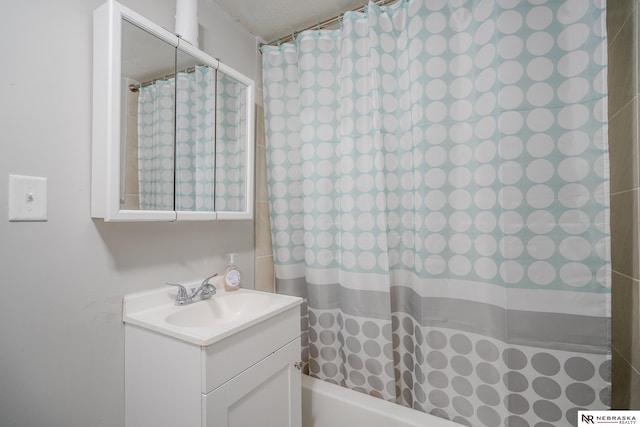 bathroom featuring vanity and shower / bath combination with curtain