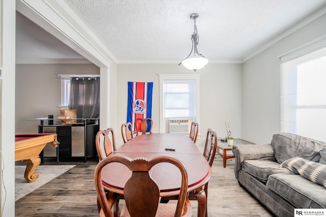 dining area featuring hardwood / wood-style flooring, ornamental molding, a textured ceiling, and billiards