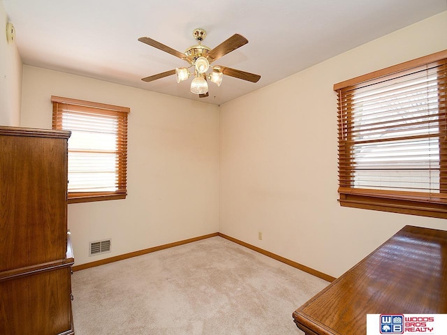 spare room featuring ceiling fan and light colored carpet