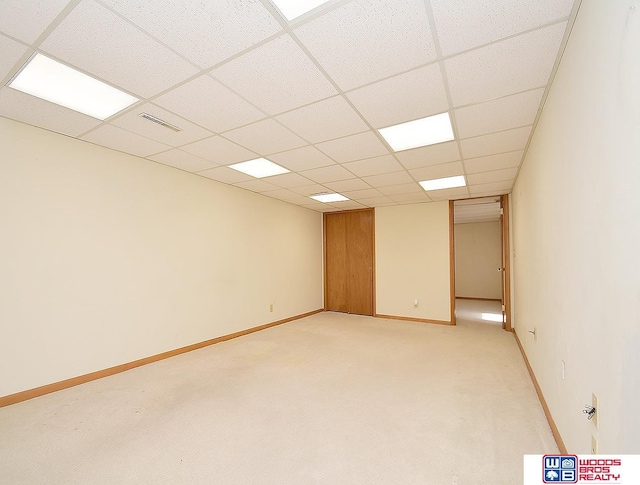 carpeted spare room with a paneled ceiling