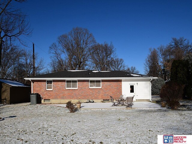 rear view of property with cooling unit and a patio area