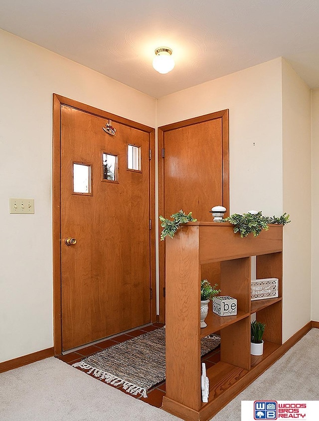 view of carpeted foyer entrance