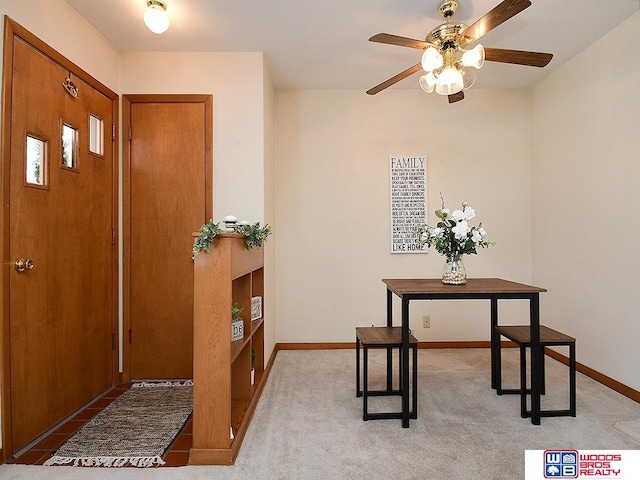 carpeted entryway with ceiling fan