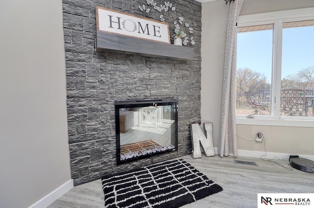 interior details featuring a fireplace and hardwood / wood-style floors