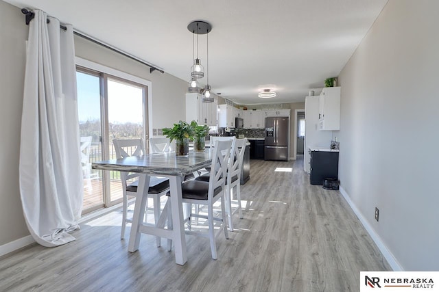 dining area with light wood-type flooring