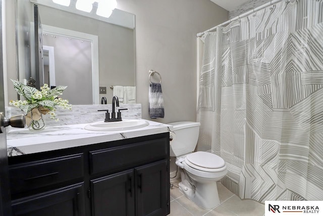 bathroom featuring tile patterned floors, vanity, and toilet