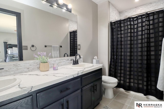 bathroom with tile patterned floors, vanity, a shower with shower curtain, and toilet