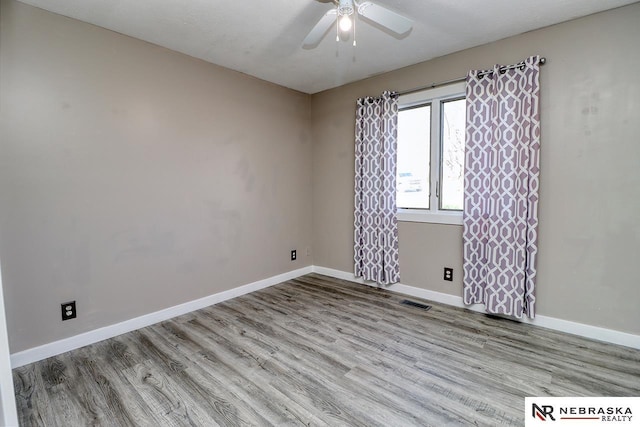 spare room with ceiling fan and light hardwood / wood-style flooring