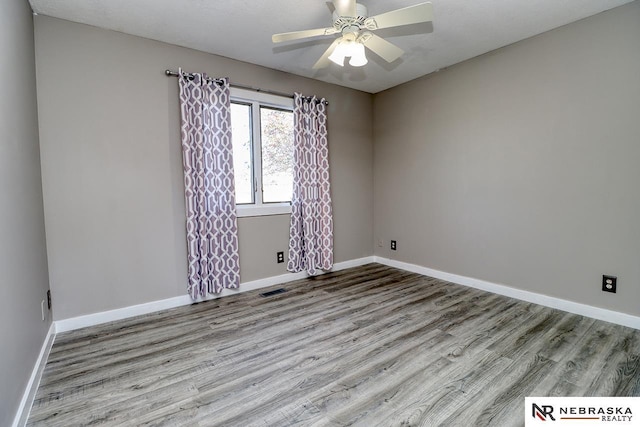 unfurnished room with ceiling fan and light hardwood / wood-style floors