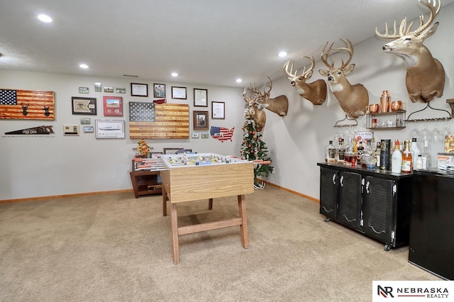 game room with light carpet and indoor bar