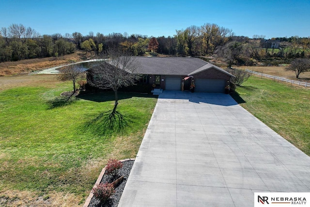 view of front of property featuring a garage and a front lawn