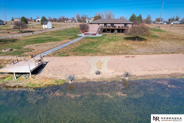 exterior space featuring a front yard and a deck with water view