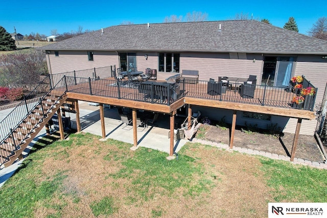 rear view of property with a yard, a patio, and a wooden deck