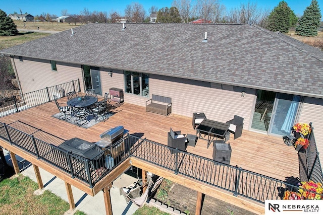 rear view of house featuring a wooden deck