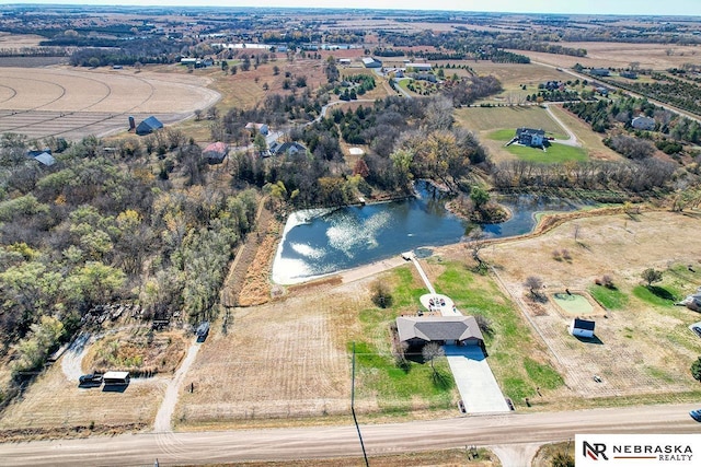 birds eye view of property featuring a rural view and a water view