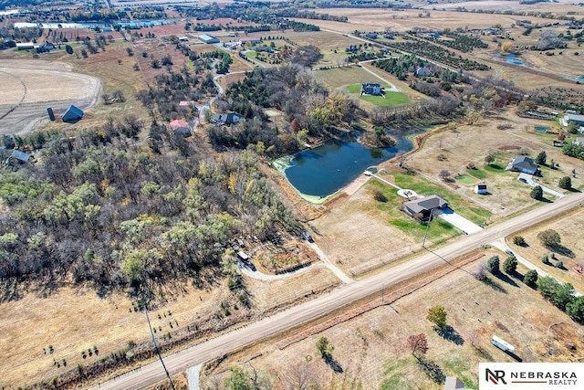 birds eye view of property featuring a water view and a rural view