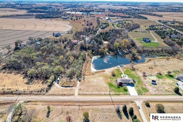 birds eye view of property with a rural view and a water view