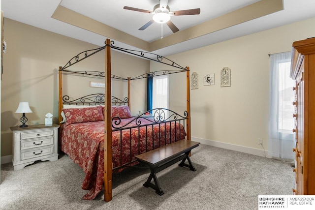 bedroom featuring a tray ceiling, ceiling fan, and carpet