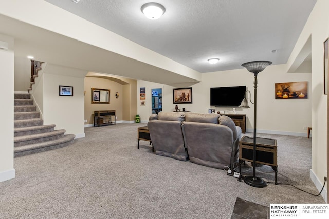 living room with carpet flooring and a textured ceiling