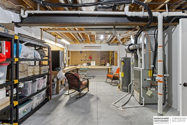 basement with a workshop area, water heater, and heating unit