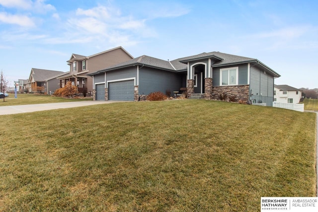 view of front of home featuring a garage and a front lawn